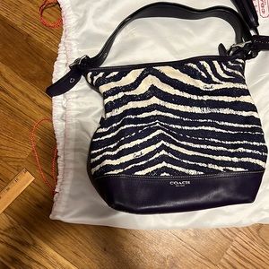 Purple and white zebra striped coach pocketbook with tassels
